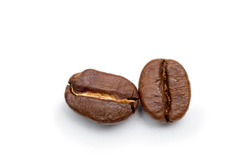 Two Roasted coffee beans placed on white background.