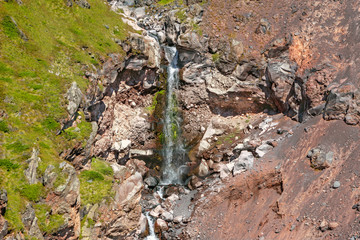 Waterfall on the slope of Mount Elbrus, shooting from the funicular