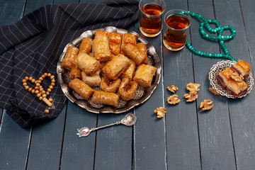 Top view of big metal tray with turkish baklava on planked wooden table
