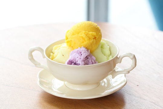 Mixed flavor ice cream scoops in bowl