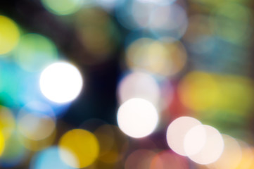 Abstract blurred color bokeh lights of night city buildings