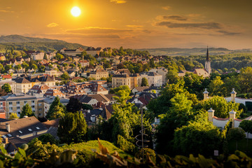 Naklejka premium View of the buildings and roofs of the picturesque town of Melk on a sunset, Lower Austria, Wachau Valley.