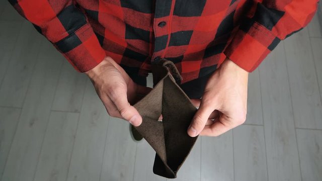 Man angry because of lack of money. Close up of male's hands showing empty lether wallet with no money. Finance business bankruptcy concept.