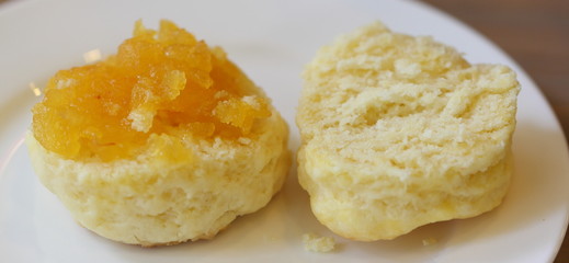 Close up homemade scone with cream and jam