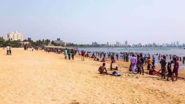 Indian people washing themselves at Girgaon Chowpatty Beach on Holi day time lapse