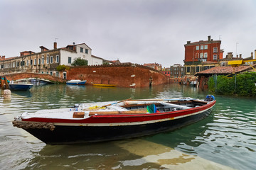 boat ancored on a canal in venice