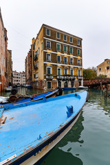 Fototapeta na wymiar gondolas and boats ancored on a canal in venice