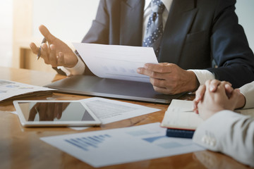 Business concept. Close up. Businessman advice to team with paperwork to analyzing budget plan and statistic.