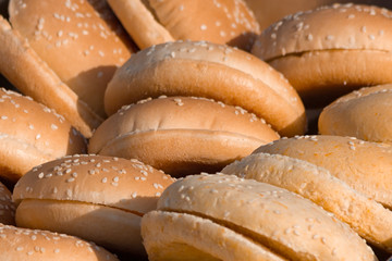 Sliced hamburger bun, ready to cook burgers.