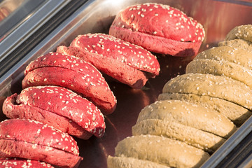 Sliced hamburger bun, ready to cook burgers.