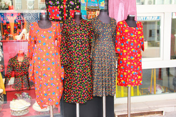 multi-colored women's dresses with a pattern of flowers on mannequin