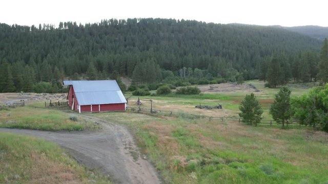Rustic Red Bard on Green Ranch Property at Sunset Slow Drone Orbit