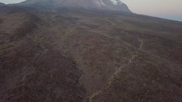 Flying backwards while tilting up, Kibo Peak during sunset.