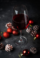 a glass of red wine in Christmas decorations