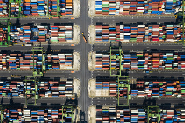 Stunning aerial view of the port of Singapore with trucks and thousands of colored containers ready...