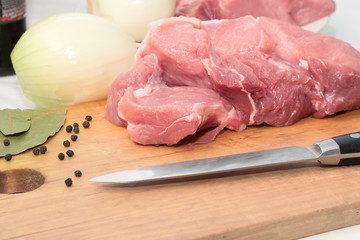 Slices of fresh raw meat on a cutting kitchen board. Cooking food