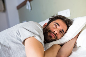 Young man sleeping in bed