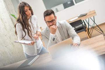 Confused business people solving work problem during meeting in office