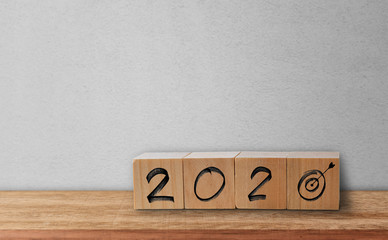 Writing word 2020 and Goal icon on wood cubes. Business success goal concept