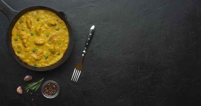 Cooking tasty chicken curry in pan with spices. Flat lay, top view with copy space