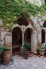 Fototapeta na wymiar Red stone column in countryard of Villa Cimbrone garden , in Ravello, Amalfi Coast, Italy