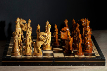 Chess pieces stand on a chessboard. There is a game of chess