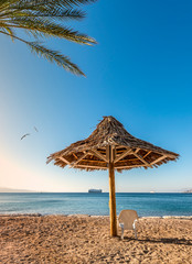 Relaxing facilities on sandy beach in Eilat - famous tourist resort and recreation city in Israel