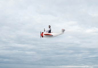 Obraz na płótnie Canvas Happy pilot driving small propeller plane