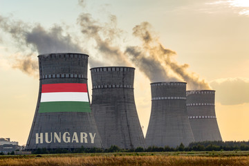 Nuclear plant chimneys displaying flag of Hungary with according text. Energy pollution accidents...