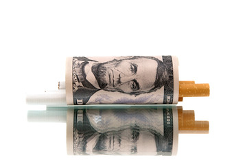 expensive habit. money and cigarettes on white background