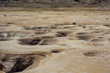 Hot geysers with mud and sulfur in the crater of a volcano