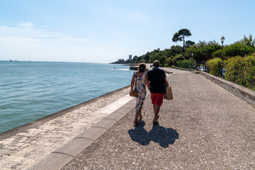 couple vacation walk harbor seaside in summer day in La Rochelle city in France