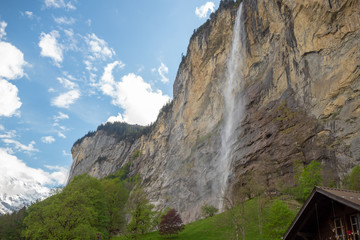 Beautiful scene of Staubbach waterfall in Lauterbrunnen with clouds blue sky , Switzerland
