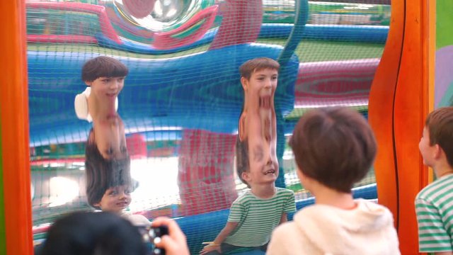 Reflection of two brothers in a distorted mirror.