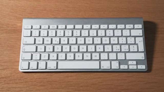 Left hand pressing shortcuts on a keyboard to cut, copy and paste