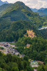 Fototapeta na wymiar Picturesque view of Bavarian castle with lake surrounded with forest.