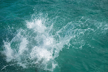 Fototapeta na wymiar Huge splashing water in the sea from people falling into water, abstract art picture for background.