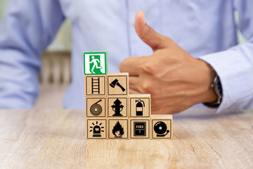 Wooded blocks Stacking with fire escape icon for safety concept.