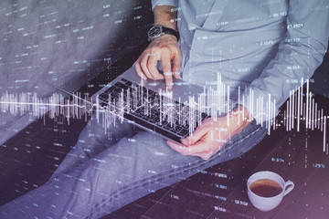 Forex graph with businessman working on computer in office on background. Concept of analysis....