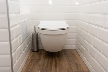 Modern toilet or WC in clean apartment or flat with white porcelain
