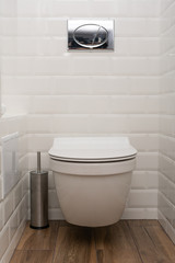Modern toilet or WC in clean apartment or flat with white porcelain