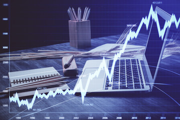 Stock market graph and table with computer background. Multi exposure. Concept of financial analysis.