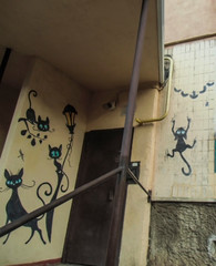 entrance to the apartment building with painted cats