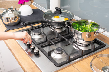 Close up on woman cooking healthy vegetables in bright kitchen