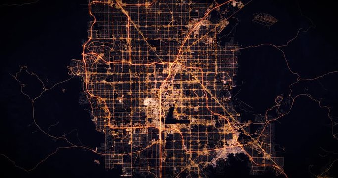 Aerial night view of city of Las Vegas, USA. Traffic and street light glowing. Camera flying high above, moving closer and rotating from space filming cinematic straight down. 3d animation rendering.