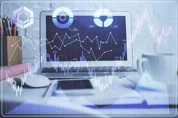 Financial chart drawing and table with computer on background. Double exposure. Concept of international markets.