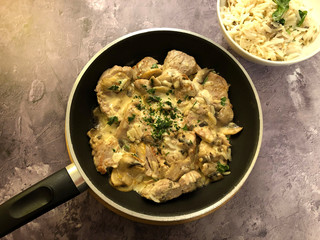 Pork medallions in creamy mushroom sauce with rice.