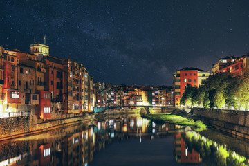 Night view of the Spanish city of Girona. old city lights, starry sky, colorful houses and the Onyar river. - 306535277