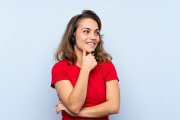 Young blonde woman working with headset looking side