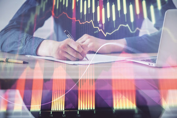 Double exposure hands with stock market chart.